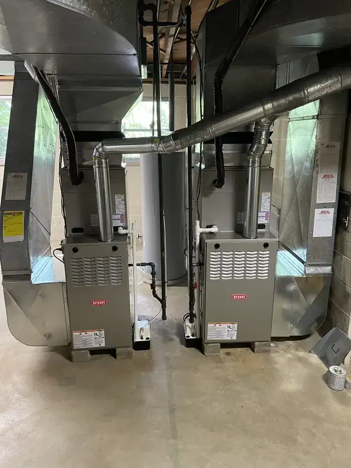 Two Bryant furnaces installed side by side with connecting ductwork